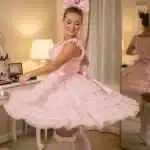 Whimsical pastel illustration of pink ruffled accessories with a vanity mirror and soft fabrics representing sissy phone sex transformation and celebration