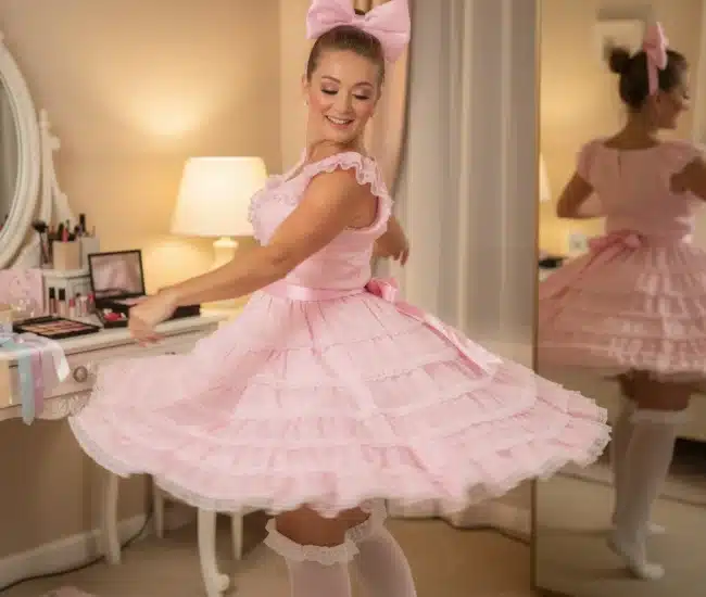 Whimsical pastel illustration of pink ruffled accessories with a vanity mirror and soft fabrics representing sissy phone sex transformation and celebration