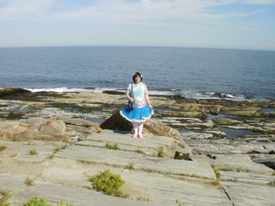 A Sissy Girl standing near the sea and enjoying during daytime
