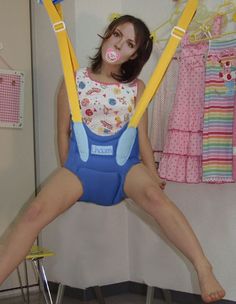 A Girl flying The Baby Walkers along with pacifier in mouth