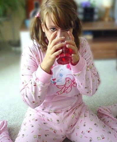 Adult Teen Girl Holding Glass Full Juice and Drinking
