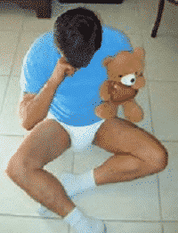 Adult Diaper Boy Lying On the Floor With Teddy Bear