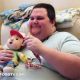 Smiley Fat man holding the toy with his hand