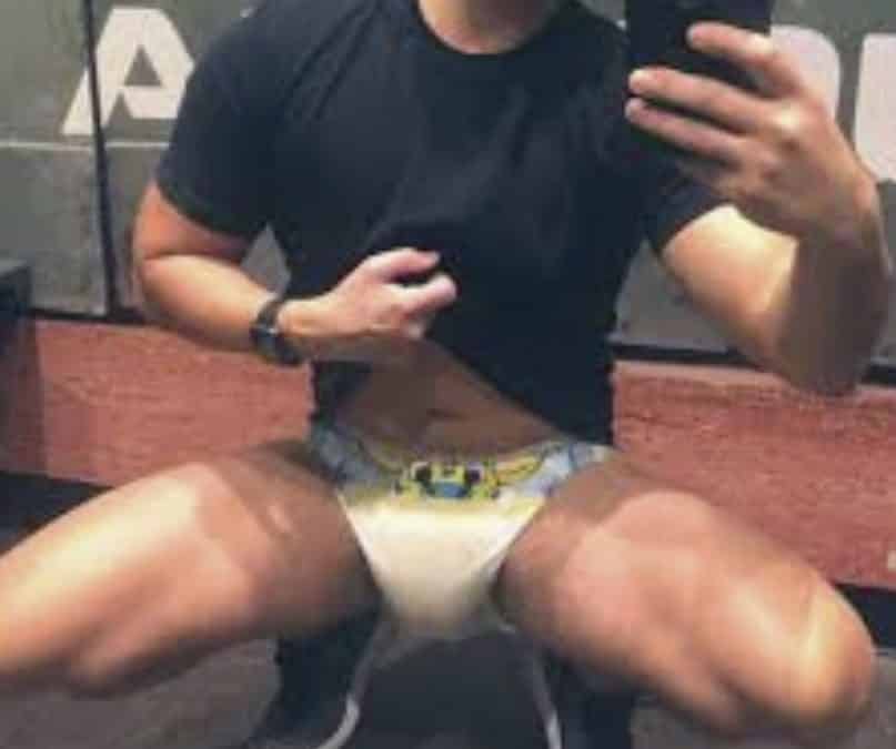 Young Man Taking diaper Selfie In Front Of Mirror At Home