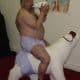 Old Man Sucking the feeding bottle and sitiing on the polar bear