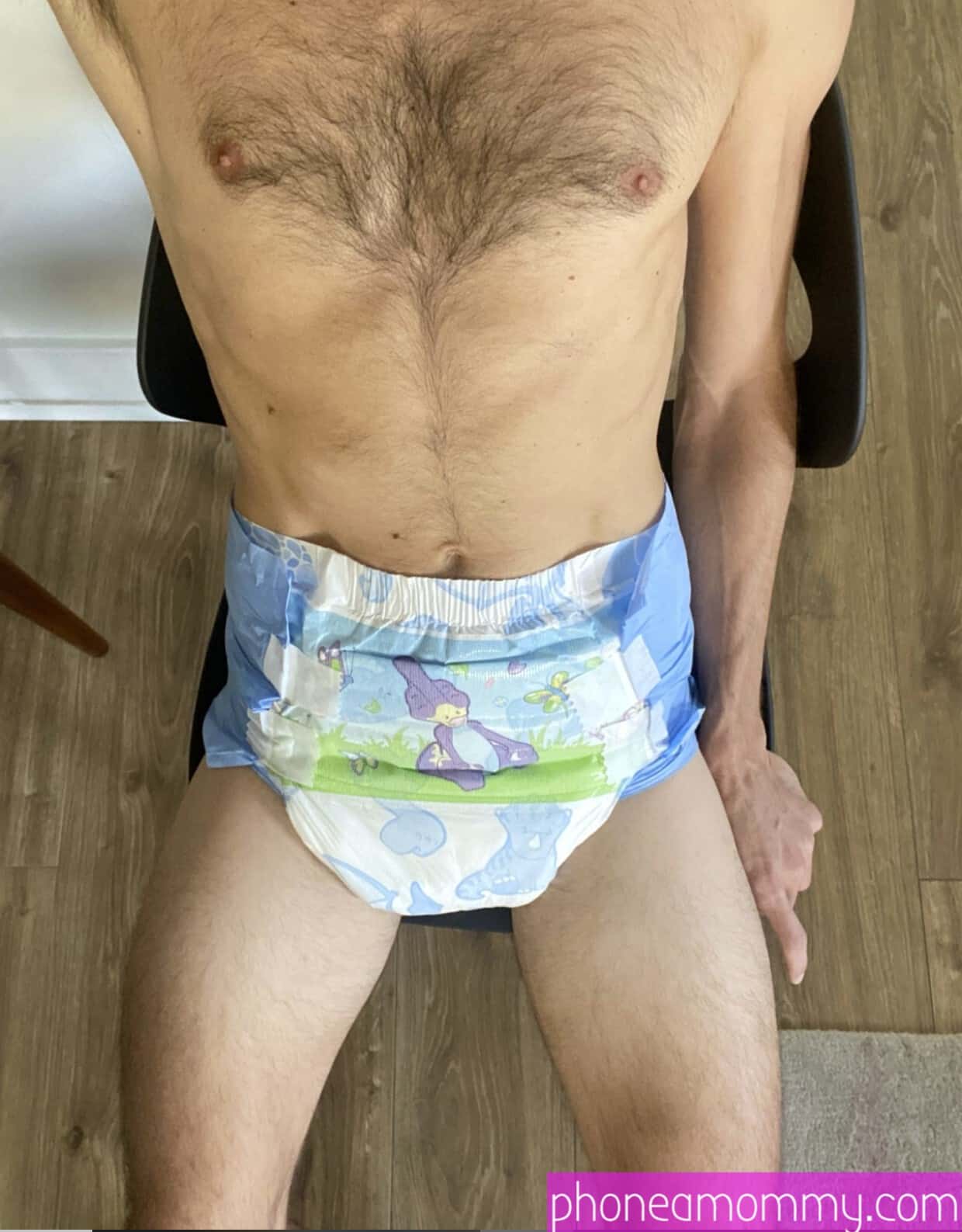 A Diaper Man Sitting In The Chair